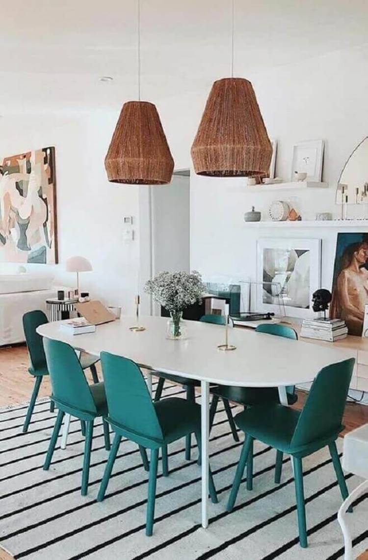 Crystal pendant for an all-white dining room with a mirrored wall.
