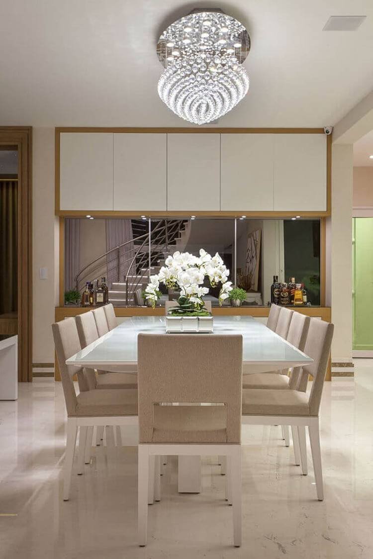 Modern pendant for a neutral dining room with a large square wooden table.