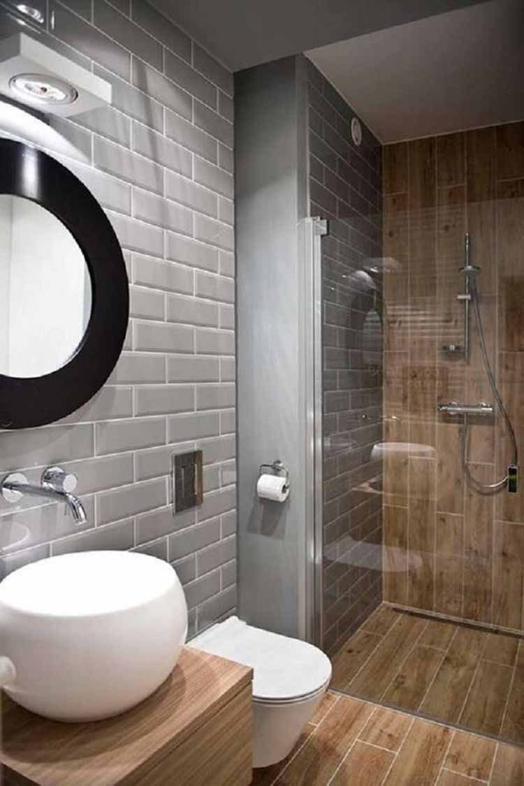 A predominantly gray and wood bathroom with black details shows the versatility of lighter wood tones.