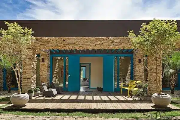 Country house with stone facade and blue door.