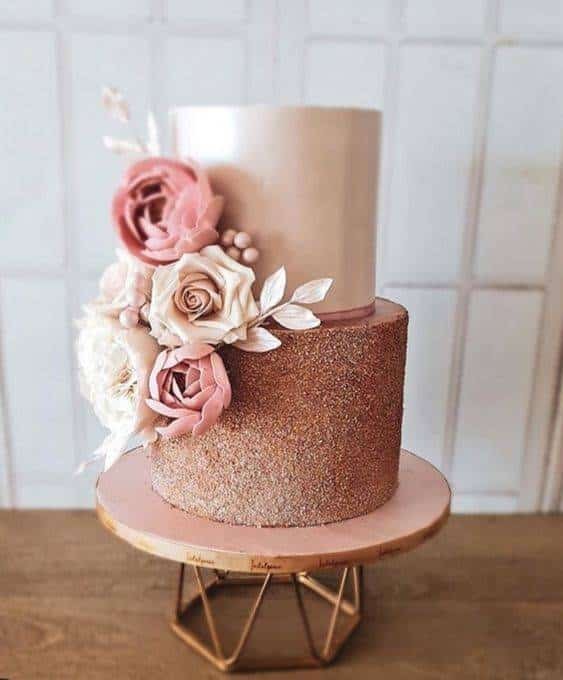14. Adding artificial flower arrangements matching the colors of each cake tier enhances its appeal.