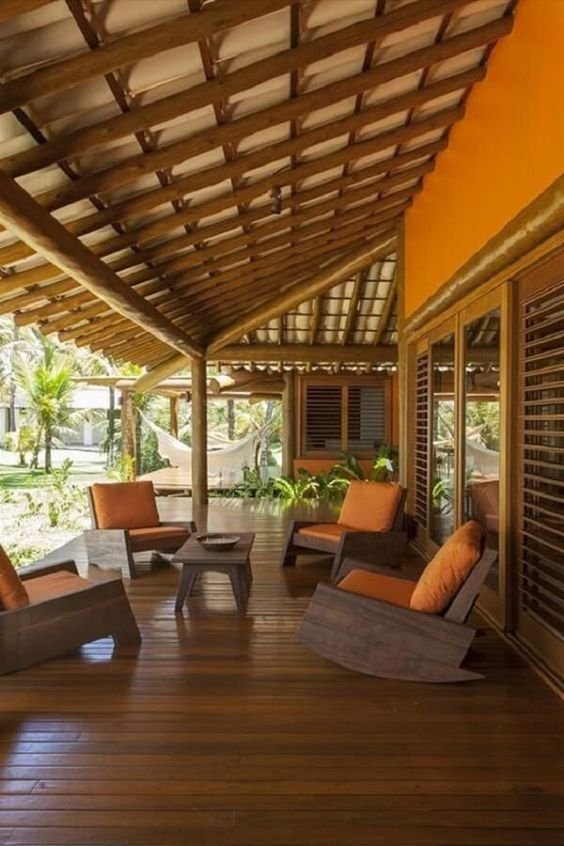 A functional porch on the facade protects against weather elements, enhancing the utility of the outdoor area.