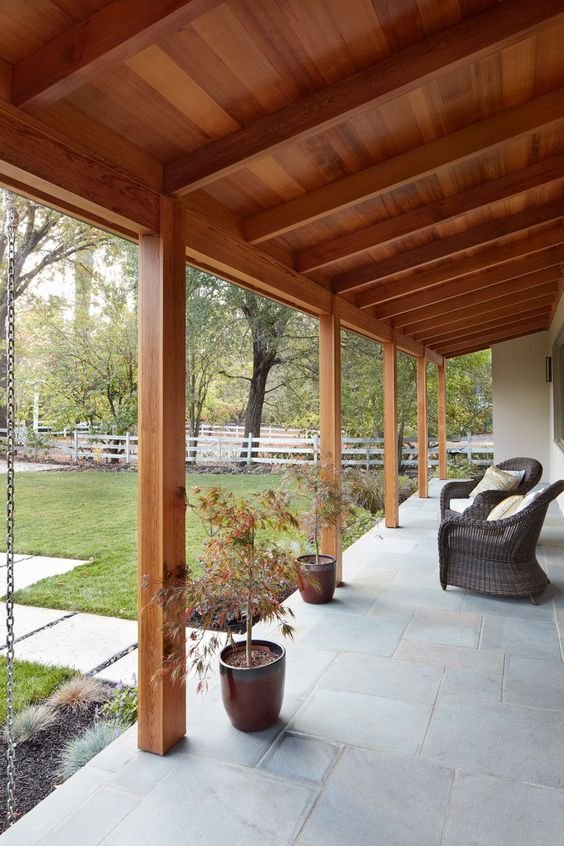 The image depicts a porch primarily made of wood, a common material choice for its durability and aesthetic appeal.