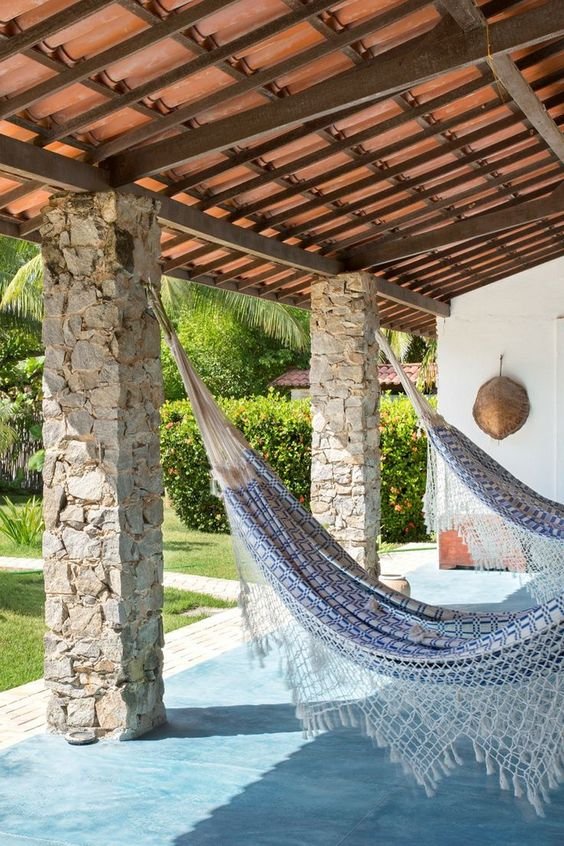 The sturdy pillars allow for the addition of hooks for hammocks, creating a relaxing outdoor space.