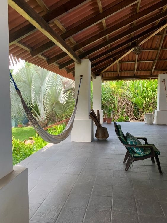 Roof tiles commonly cover porch areas, adding a classic and pleasing finish while extending beyond the pillars.