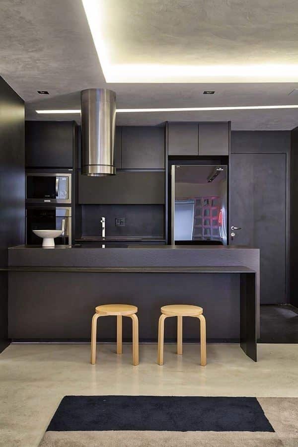 14. Entirely black kitchens work well, especially with custom furniture for a cohesive design.