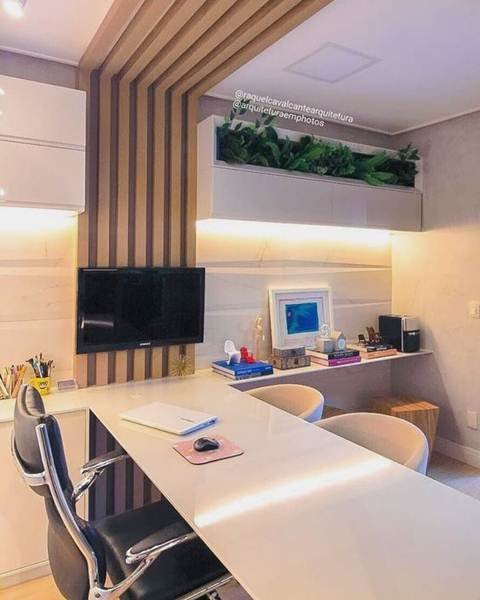 A lateral stripe with stripes elongates the small office space, and the shelf with plants brings more freshness to the location.