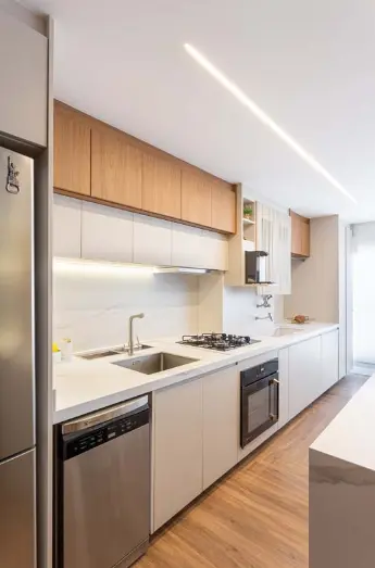 Light wood details are always welcome in a modern white kitchen. Project: Rafaella Grasnoff – Loft 7 Arquitetura | Photo: Dam Mol