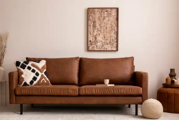 Colors like orange or red contrast nicely with the brown sofa.