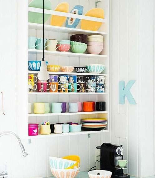 3. Here, a large, rectangular kitchen niche with shelves is decoratively filled with cute kitchen utensils, creating an additional functional space.
