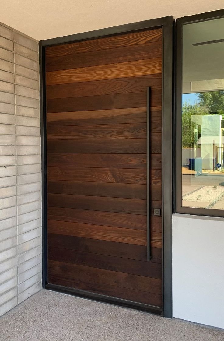 Iron and wood door with prominent wooden features and iron borders and handle.