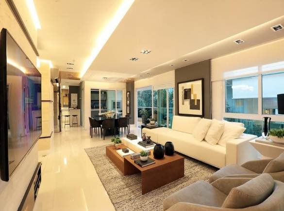 1. Note how the sofas and the rug that follows their lengths create a compact space in the long room. Some parts of the wall painted with a more prominent color also help break up the length of the place.