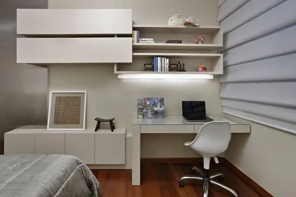 White shelf with niches and built-in lamp.