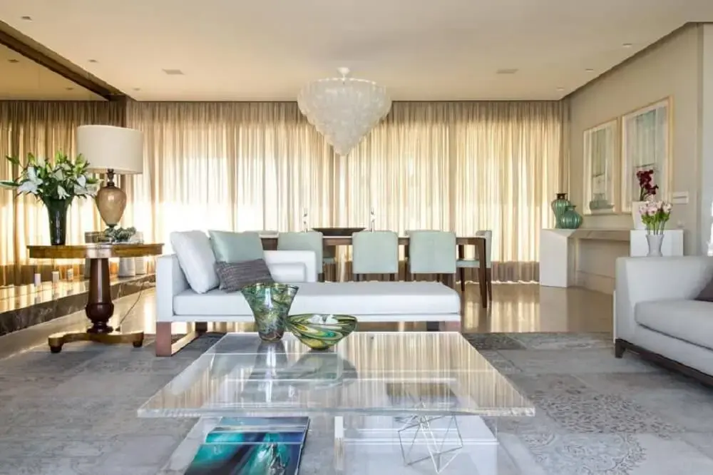 Sala de estar com mesa de centro de vidro. Projeto Marília Veiga