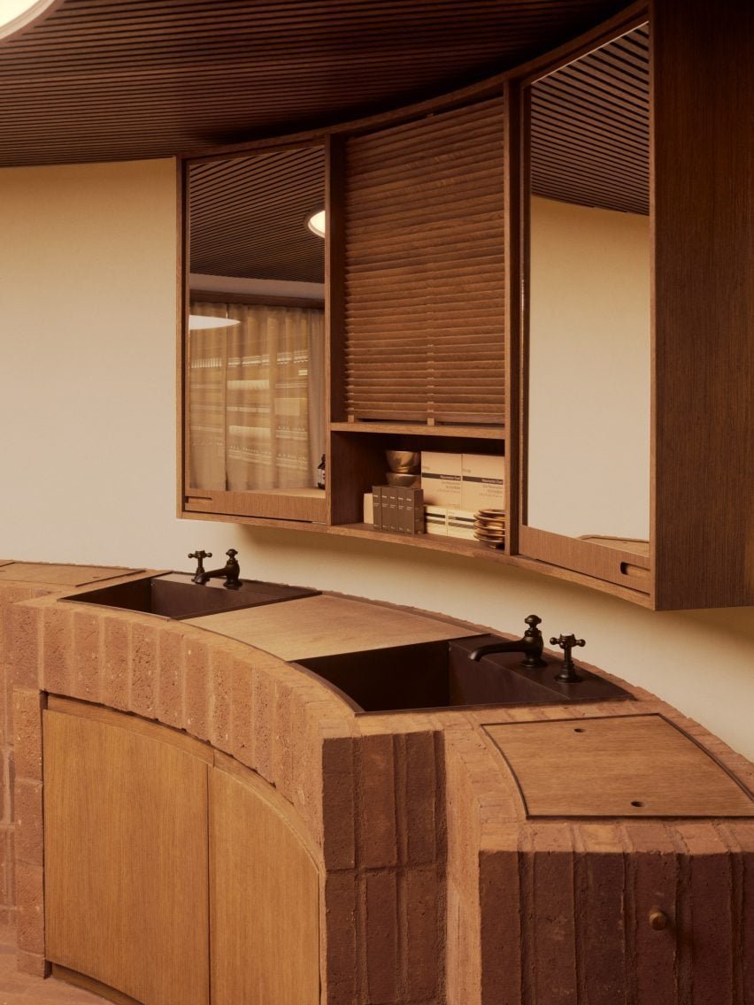 Um espaço interno com um lavabo em uma área circular e revestido em tijolos.