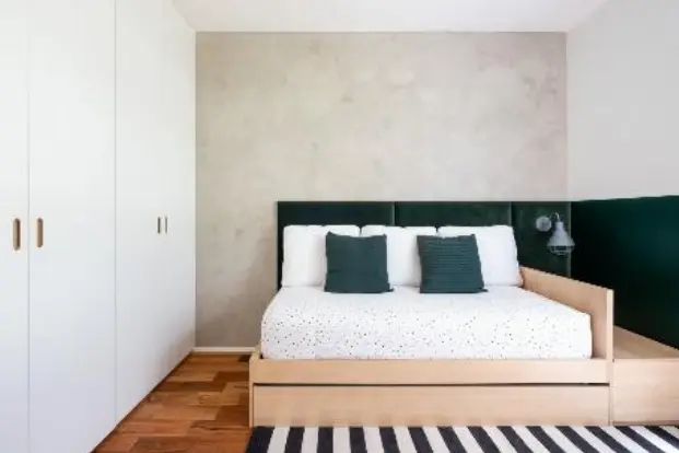 A modern masculine bedroom with upholstered headboard and green tones. Project by SP Estúdio | Photo by Nathalie Artaxo.