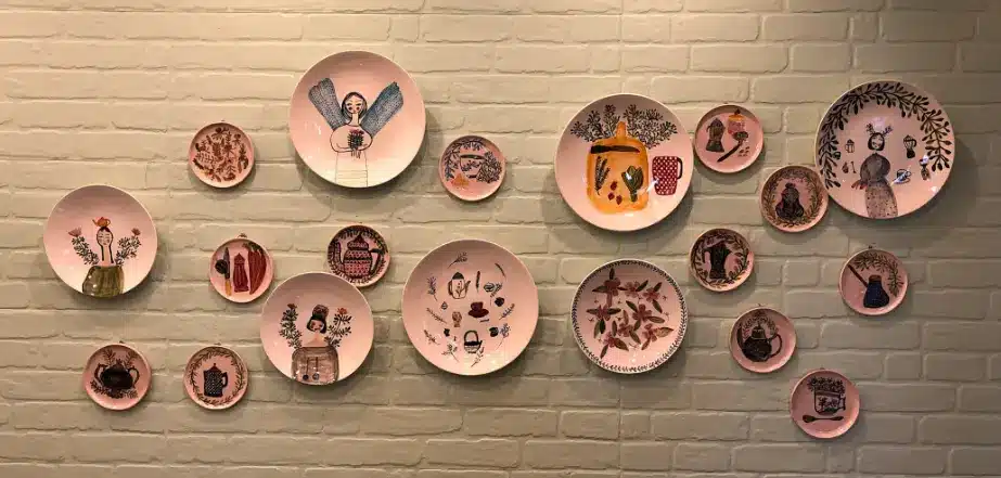 Crie uma parede vibrante com pratos de porcelana coloridos, combinando cores e padrões que se harmonizem com o estilo do seu espaço.