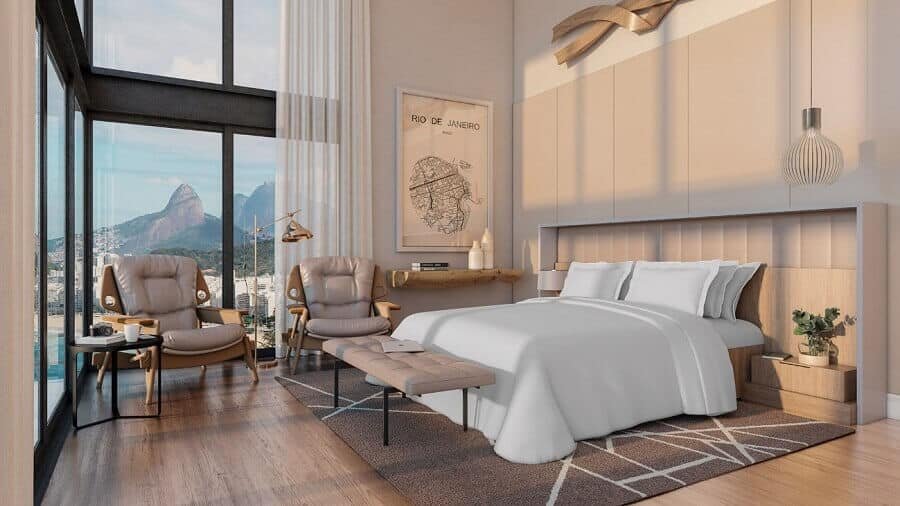 Decorated hotel room in neutral colors with ample windows